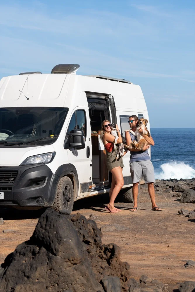 Marcus and Jessica holding Rory and Jeannie by the van